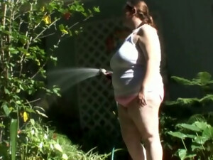 Horny BBW Whore Plays With A Hose In The Garden While Stripping